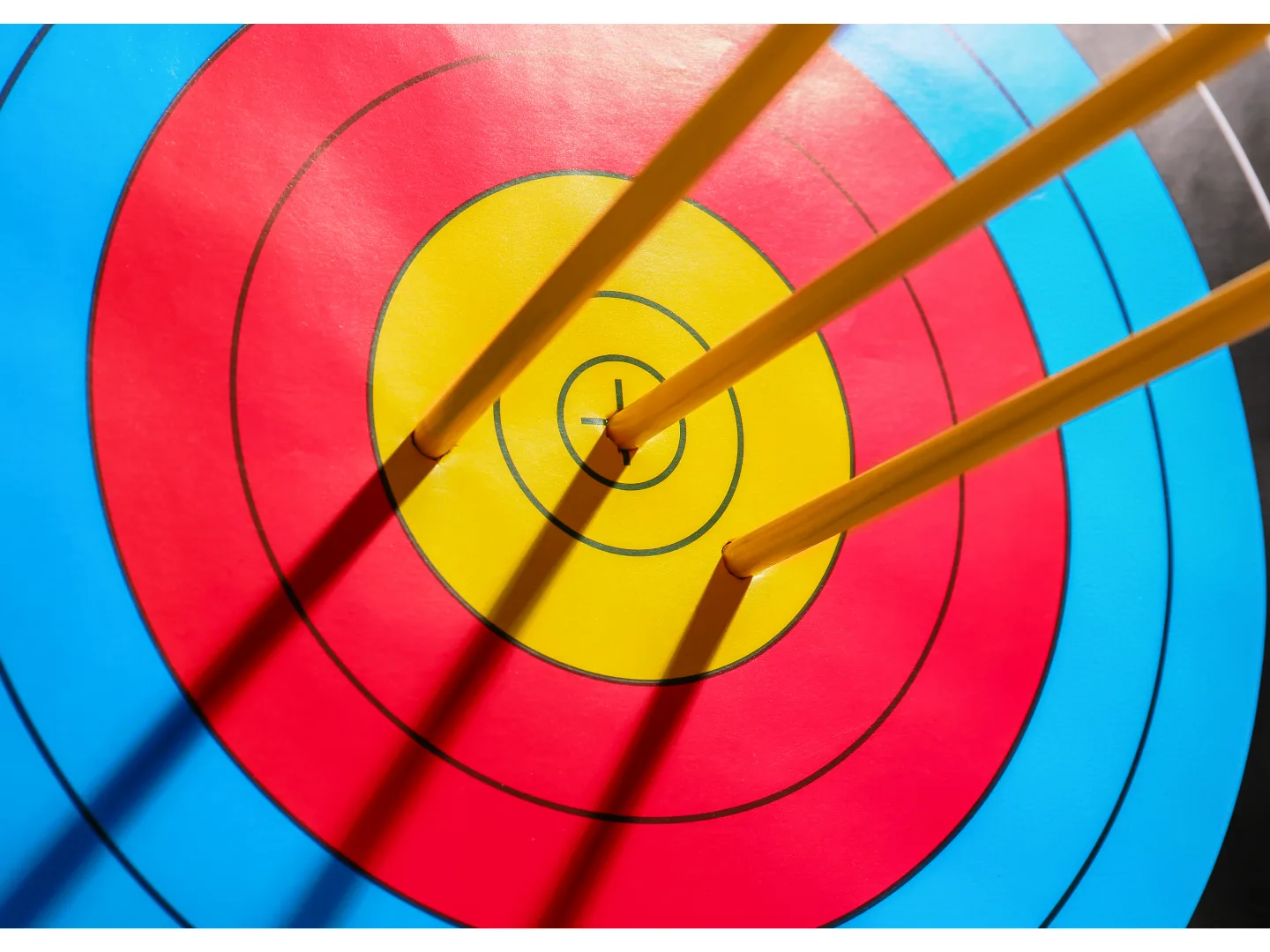 A close-up of an archery target with arrows hitting the bullseye, symbolizing precision and accuracy in pricing strategies for maximizing profit