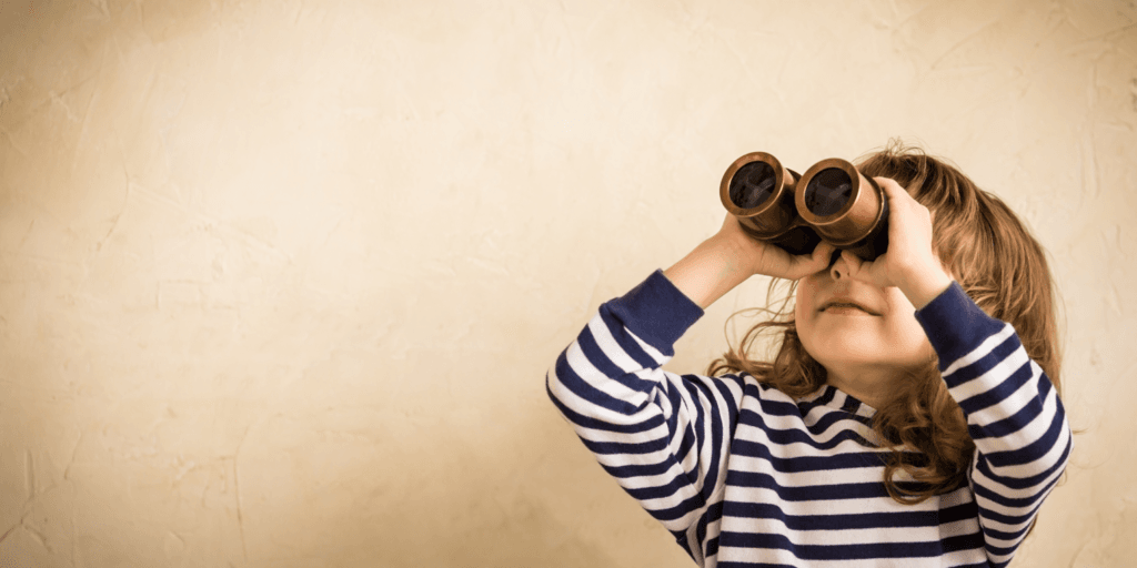 Young child wearing a striped shirt looking through binoculars with a focused expression, symbolizing the search for insights and trends.