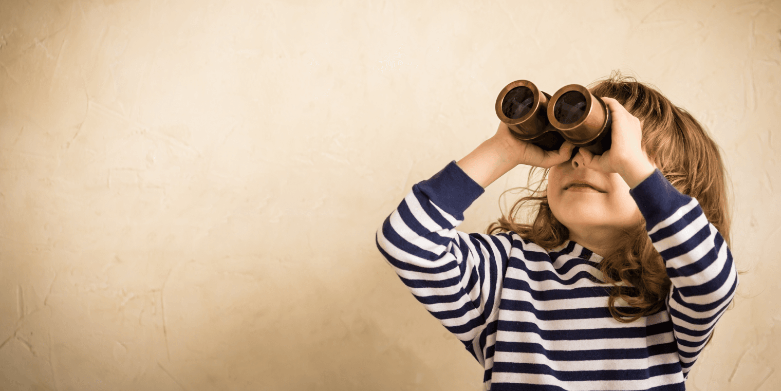 Young child wearing a striped shirt looking through binoculars with a focused expression, symbolizing the search for insights and trends.