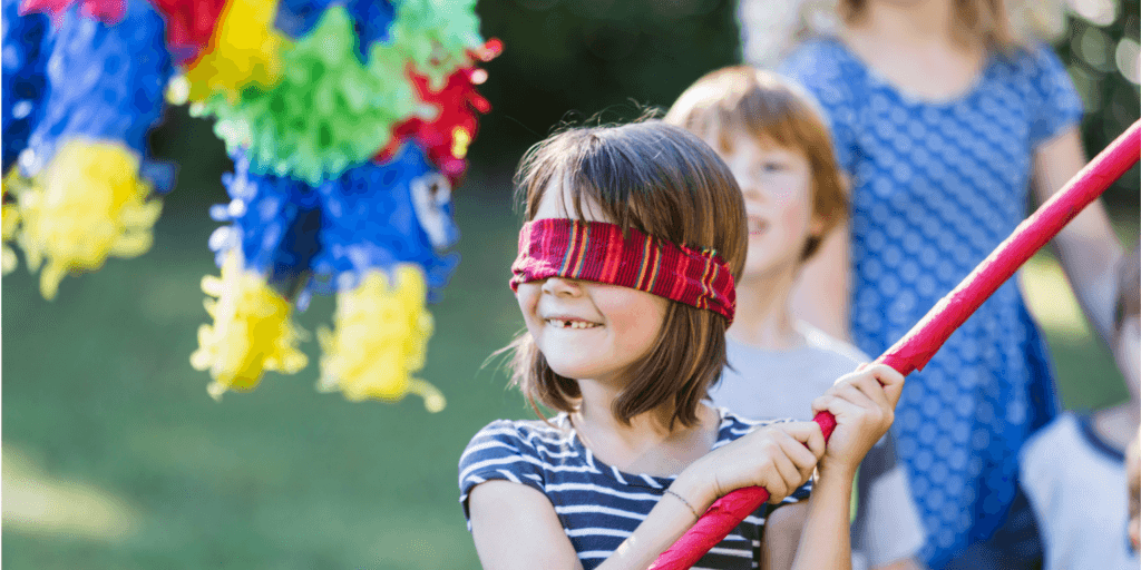 Blindfolded person attempting to hit a piñata, symbolizing the risk of ignoring concept testing in product development